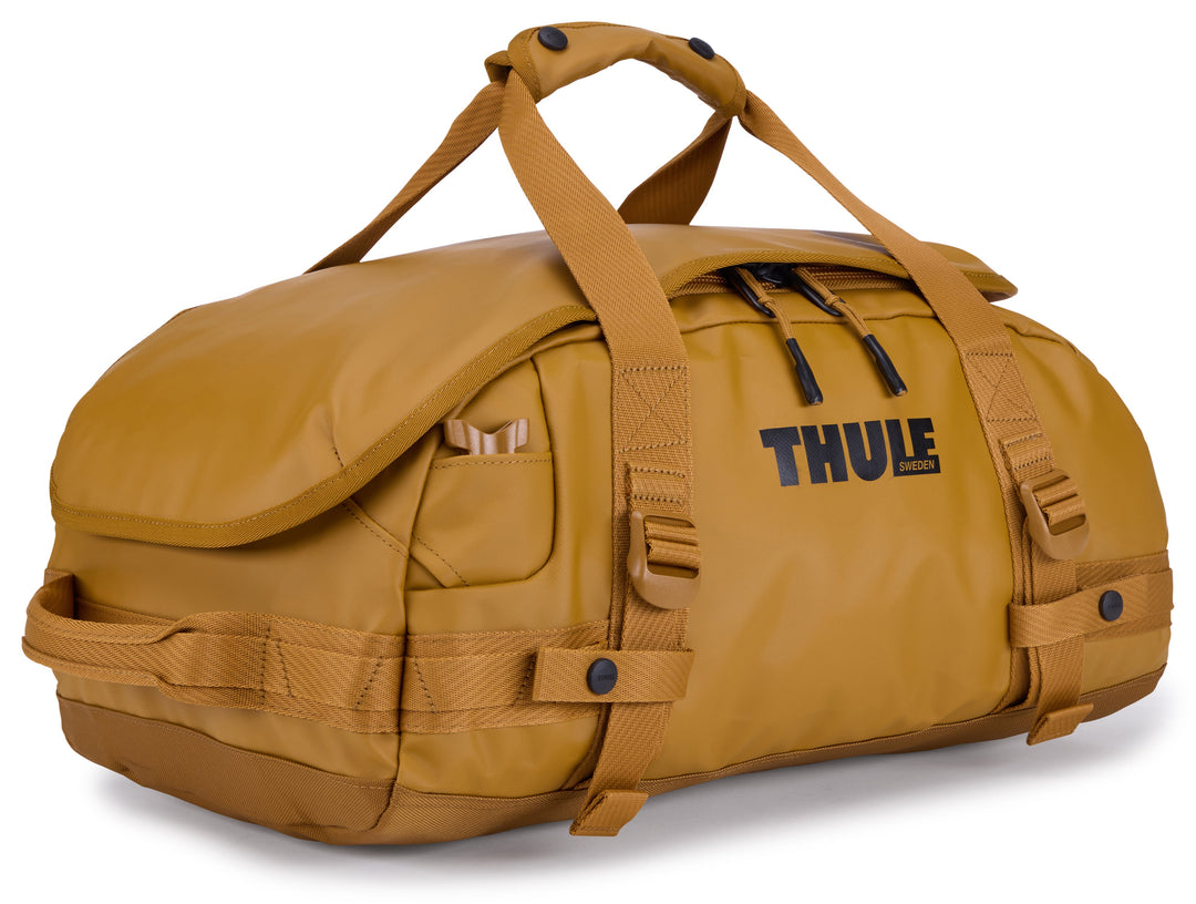 Brown duffel bag with 'Thule' branding on a white background
